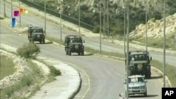 Syrian military vehicles leave Daraa, May 5, 2011 in this still image taken from video