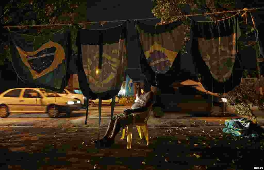 Reginaldo, a Brazilian flag seller, waits for customers sitting in traffic just days before the 2014 World Cup events begin, Cuiaba, June 10, 2014.