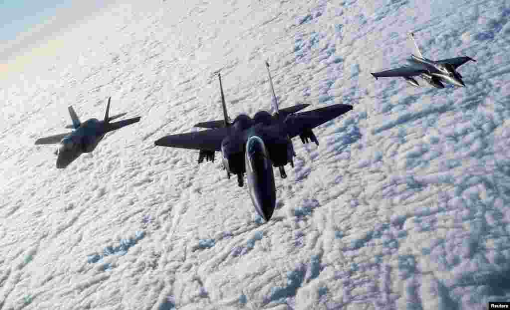 An RAF F-35B Lightning, a USAF F-15E Strike Eagle and a French Rafale fly over The English Channel in formation during the &quot;Point Blank&quot; exercise, after taking off from RAF Mildenhall, Britain, Nov. 27, 2018.