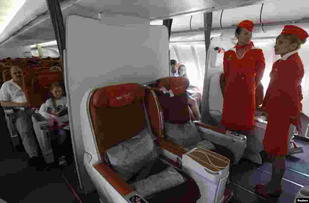 People sit onboard an Aeroflot Airbus A330 heading to the Cuban capital Havana at Moscow&#39;s Sheremetyevo airport, Russia. A Russian passenger plane left Moscow for Havana without any sign of former U.S. spy agency contractor Edward Snowden on board, witnesses said.