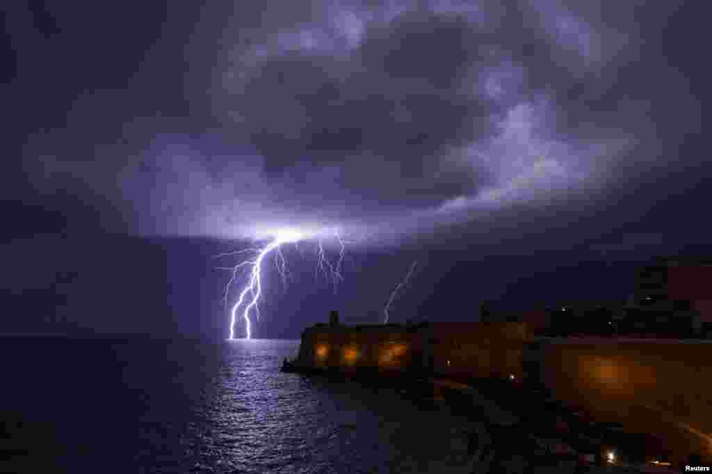 Lightning strikes the sea near Fort St. Elmo during a storm in Valletta, Malta, Feb. 27, 2019.