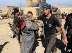 FILE - Iraqi special forces arrest a suspected Islamic State fighter in Mosul, Iraq, Feb. 25, 2017.