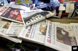 Newspaper headlines show Italian Premier Matteo Renzi's resignation following the result of a constitutional referendum, at a newsstand in Rome, Dec. 5, 2016.
