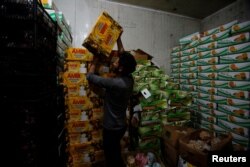 A man carries a box of Iranian dates in Baghdad, Iraq, March 14, 2018.