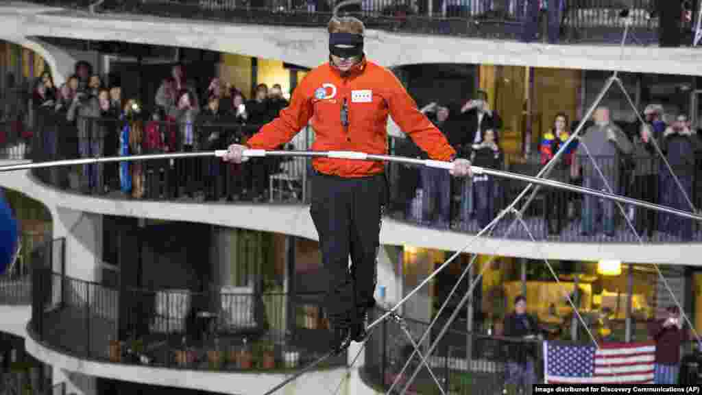 Nik Wallenda, blindfolded, walks across the Chicago skyline for Discovery Channel's Skyscraper Live with Nik Wallenda, Nov. 2, 2014. 