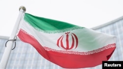 FILE - The flag of Iran waves in front of the International Center building with the headquarters of the International Atomic Energy Agency, IAEA, in Vienna, May 24, 2021.