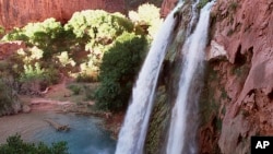 FILE - This 1997 file photo shows one of five waterfalls on Havasu Creek as its waters tumble 210 feet on the Havasupai Tribe's reservation in a southeastern branch of the Grand Canyon near Supai, Arizona. (AP Photo/Bob Daugherty, File)