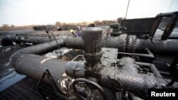 Engineers check oil pipelines in a largely damaged oilfield, Heglig, South Kordofan state, Sudan, April 23, 2012.