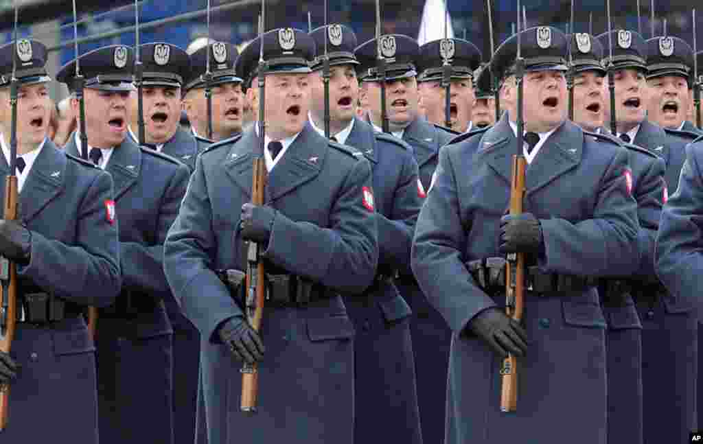 Polish soldiers salute during the the 97th anniversary of &nbsp;Independence Day ceremonies in Warsaw.