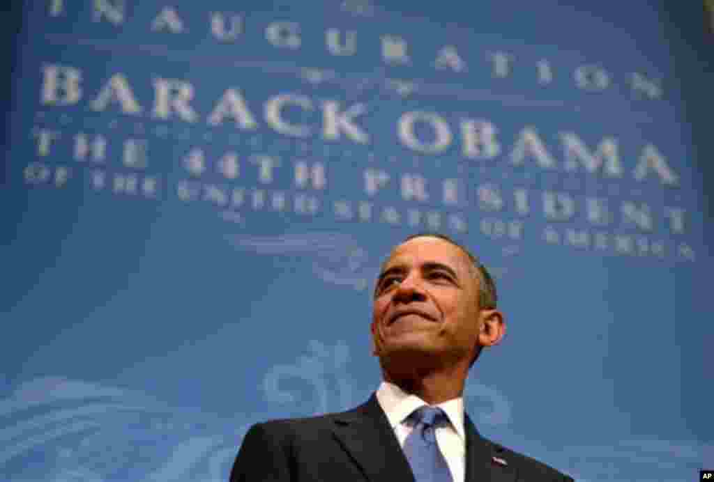 US President Barack Obama listens as First Lady Michelle Obama delivers remarks at the Inaugural Reception at the National Building Museum in Washington, DC, USA, 20 January 2013. Obama defeated Republican candidate Mitt Romney on Election Day 06 November