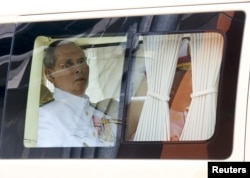 Thailand's King Bhumibol Adulyadej sits in a vehicle as he leaves Siriraj Hospital for the Grand Palace to join a ceremony marking Coronation Day in Bangkok, Thailand, May 5, 2015.