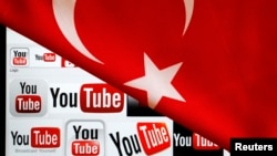 YouTube logos displayed on a laptop screen partially covered with Turkey's national flag in this photo illustration taken in Ankara March 27, 2014. 