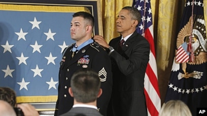 Army Sgt. 1st Class Leroy Arthur Petry applauds during a ceremony at the  White House in