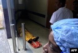 A man lies at the floor in the emergency area of Dr. Miguel Perez Carreno Hospital, in the west of Caracas, Venezuela, Dec. 31, 2018.