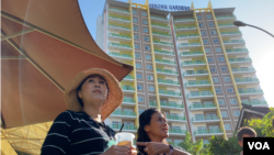 Sitanun Satsaksit stands in front of Mekong Gardens condominium where her brother, Wanchalearm Satsaksit, was allegedly abducted six months ago in Phnom Penh, Cambodia, on December 04, 2020. (Aun Chhengpor/VOA Khmer)