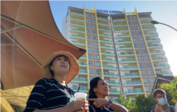 FILE - Sitanun Satsaksit stands in front of Mekong Gardens condominium where her brother, Wanchalearm Satsaksit, was allegedly abducted six months ago in Phnom Penh, Cambodia, on December 4, 2020. (Aun Chhengpor/VOA Khmer)
