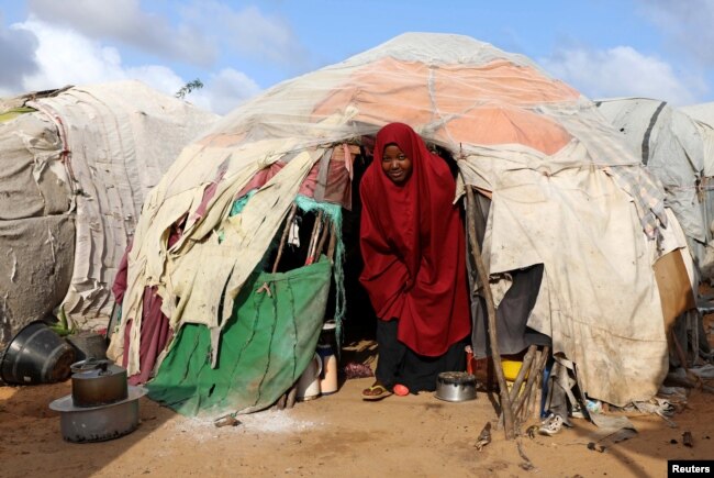 A Somali woman walks out from her makeshift shelter at a camp for the internally displaced people outside Mogadishu, Somalia August 28, 2018.