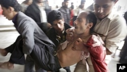 A wounded protestor is carried from the site of clashes with security forces in Sana'a, Yemen, November 24, 2011.