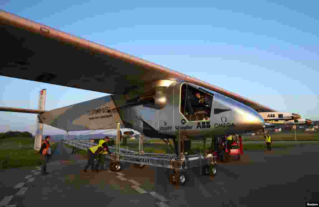 The new Solar Impulse 2 aircraft is pulled out of its base for the first time for tests with solar panels in Payerne, Swizerland. An attempt to fly around the world in stages using only solar energy will be made in 2015.