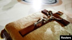 FILE - A crucifix is placed on a cushion in St. Patrick's Cathedral in New York.