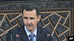 Syrian President Bashar al-Assad addresses the nation during a speech in Damascus, Syria