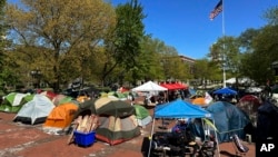 FILE - Pro-Palestinian protesters set up a camp at the University of Michigan in Ann Arbor, Michigan, May 2, 2024. Authorities have filed charges against nine people accused of trespassing or resisting police during the May breakup of a pro-Palestinian camp at the the school.