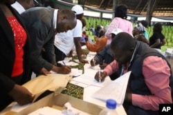 Members of the public fill out public participation forms at a public forum for an impeachment motion against Kenya's deputy president Rigathi Gachagua, at Bomas of Kenya, in Nairobi, Oct. 4, 2024.