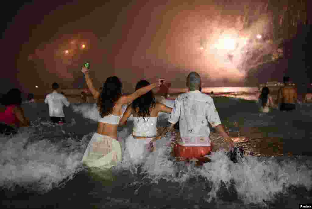 People gather at Copacabana beach to celebrate the New Year, in Rio de Janeiro, Brazil, Jan. 1, 2025. 