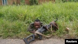FILE - A Democratic Republic of the Congo soldier rests next to a road in North Kivu province, Democratic Republic of Congo, Dec. 11, 2018.