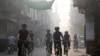 Cyclists ride along a street as they participate in an awareness campaign against smog and pollution in Lahore on November 3, 2024.