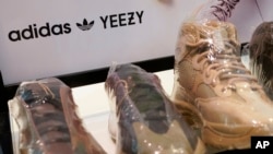 FILE: A sign advertises Yeezy shoes made by Adidas at Kickclusive, a sneaker resale store, in Paramus, N.J., Tuesday, Oct. 25, 2022. Adidas has ended its partnership with the rapper formerly known as Kanye West over his offensive and anti-semitic remarks, 