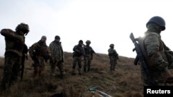 Soldiers from Carpathian Sich international battalion conduct manoeuvres near the front line, near Kreminna