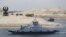 The ship 'Long Life Egypt' crosses a new section of the Suez Canal in Ismailia, Egypt, Aug. 6, 2015. The canal was extended in hopes of powering an economic turnaround. But toll revenues have fallen in September, dampening hopes that a new parallel waterway will boost the economy in the immediate future.