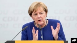 FILE - German Chancellor and top candidate of the Christian Democratic Union, CDU, Angela Merkel speaks during an election campaign in Delbrueck, western Germany, Sept. 10, 2017.