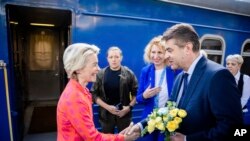 President of the European Commission, Ursula von der Leyen, left, is greeted as she arrives at the railway station in Kyiv, Ukraine, Sept. 20, 2024. 