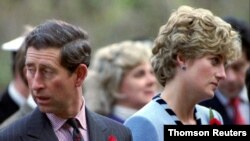 FILE PHOTO: Princess Diana and Prince Charles look in different directions, November 3, during a service