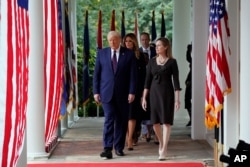 President Donald Trump walks along the Colonnade&nbsp;with Judge Amy Coney Barrett to a news conference to announce her as his nominee to the Supreme Court, at the White House, Sept. 26, 2020.