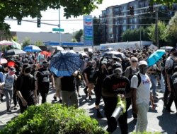 Protesters march near the King County Juvenile Detention Center, July 25, 2020, in Seattle in support of Black Lives Matter and against police brutality and racial injustice.