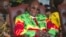 FILE: Zimbabwean President Robert Mugabe smiles during a youth rally in Marondera about 100 kilometers east of Harare, June, 2, 2017. 