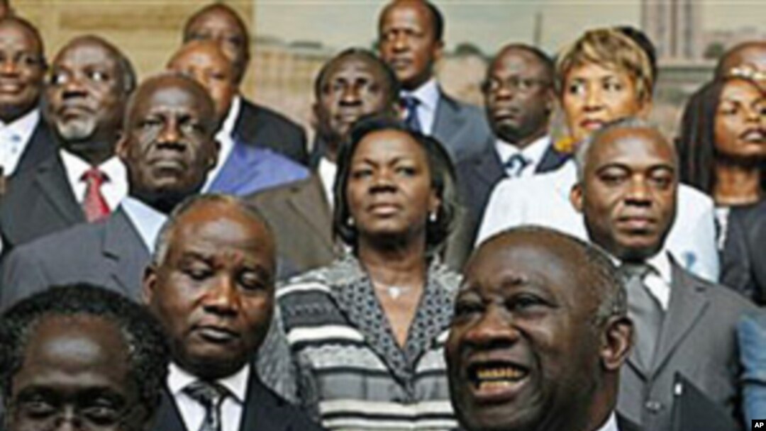 Incumbent President Laurent Gbagbo, center, gestures during a photo opportunity with his newly-named cabinet, with Prime Minister N'Gbo Gilbert Marie Ake, front left, at the presidency in Abidjan, Ivory Coast, Dec 7, 2010