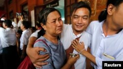 A student protester (C) and his family member cry after he was released by the new government's general amnesty at Tharrawaddy court, Tharrawaddy, Bago division, April 8, 2016. 