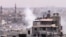 This image made from amateur video purports to show smoke rising from buildings in Homs, Syria. Syrian forces renewed shelling of the central city of Homs on Monday, one day after the head of the U.N. observers' mission demanded that warring parties allow