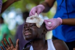 A boy injured after Saturday's 7.2 magnitude quake cries while being treated at the Ofatma Hospital, in Les Cayes, Haiti, August 18, 2021.