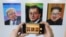 A visitor takes images, from left, of U.S. President Donald Trump, South Korean President Moon Jae-in and North Korean leader Kim Jong Un during an exhibition at an annex of the presidential Blue House in Seoul, South Korea, Jan. 3, 2019. 