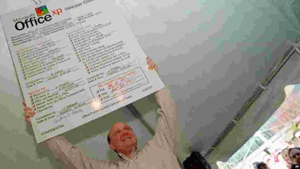 Microsoft CEO Steve Balmer holds a placard checklist for the new Microsoft Office XP at a release party for the software on March 2, 2001, on the Microsoft Campus in Redmond, Washington.