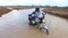 A motorcycle rider crosses a flooded section of the road in Hola, Kenya, on Nov. 7, 2023. Heavy rain and flooding killed 15 people in Kenya recently.