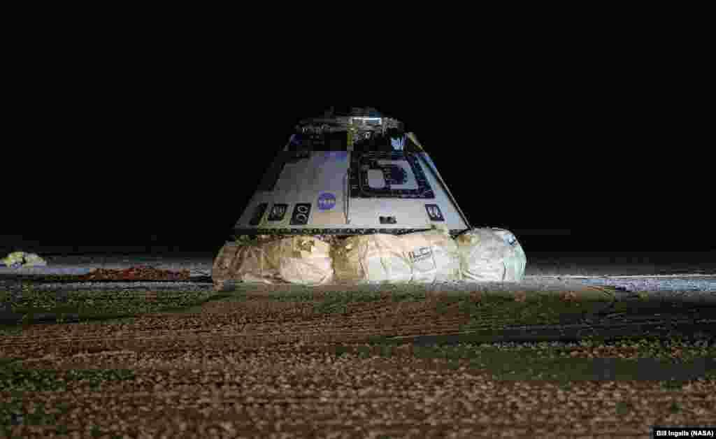 The Boeing CST-100 Starliner spacecraft is seen after it landed in White Sands, New Mexico. The landing completes an abbreviated Orbital Flight Test for the company that still meets several mission objectives for NASA&rsquo;s Commercial Crew program.