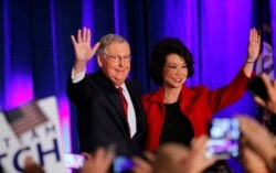 FILE - U.S. Senate Minority Leader Mitch McConnell waves to supporters with his wife, Elaine Chao, at his midterm election night rally in Louisville, Ky., Nov. 4, 2014.
