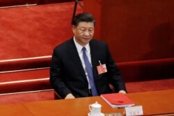 FILE - Chinese President Xi Jinping attends the closing session of the National People's Congress (NPC) at the Great Hall of the People in Beijing, China, May 28, 2020.