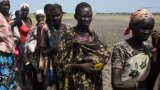 FILE - People queue for food being distributed in Unity state, South Sudan.